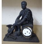 A late Victorian cast iron cased mantel clock, fashioned as a seated Roman soldier,