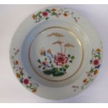 A late 18thC Chinese porcelain deep charger, decorated in famille rose with flowers,