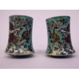 A pair of late 19thC Chinese biscuit glazed famille verte porcelain scroll ends,