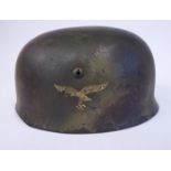 A German parachutist's camouflage helmet with a hide lining,