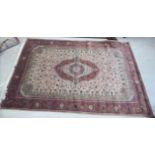 A Persian part silk/part woollen carpet with a central oval medallion,