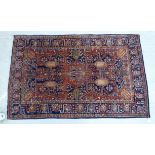 A Kashan rug, decorated with stylised designs and foliage,