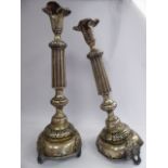 A pair of late 19thC Russian silver candlesticks, each with a vase shaped socket, over a tapered,