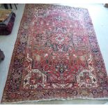 A Persian carpet, profusely decorated with stylised foliage and other designs,