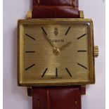 A Corum 18ct gold rectangular cased wristwatch, faced by a baton dial,