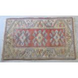A Caucasian rug, decorated with stylised designs,