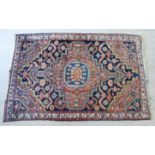 A Persian rug with a central octagonal medallion, bordered by stylised designs,