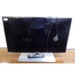 A Samsung 30'' flatscreen television with a remote control BSR