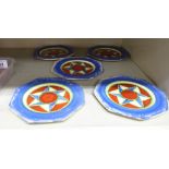 A set of five Clarice Cliff Bizarre pottery octagonal plates, decorated in blue, red and green,