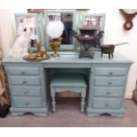 A modern washed green painted pine dressing table with eight drawers,