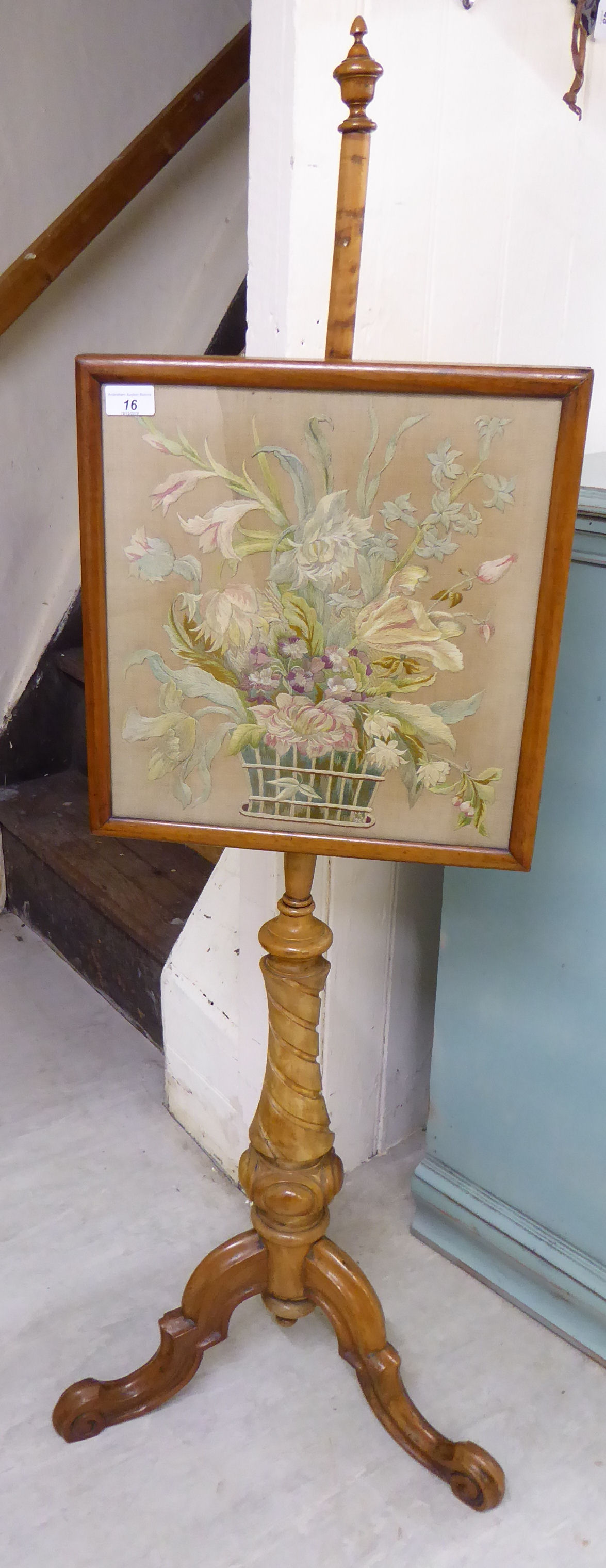A 20thC reproduction of a Victorian walnut polescreen with a floral tapestry panel,