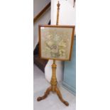 A 20thC reproduction of a Victorian walnut polescreen with a floral tapestry panel,