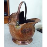 A late Victorian spot hammered copper coal bin with a fixed rear, folding top handle,