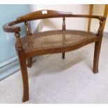 A child's Victorian style mahogany showwood framed chair with a carved seat,