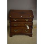 A small mahogany waterfall chest of three drawers