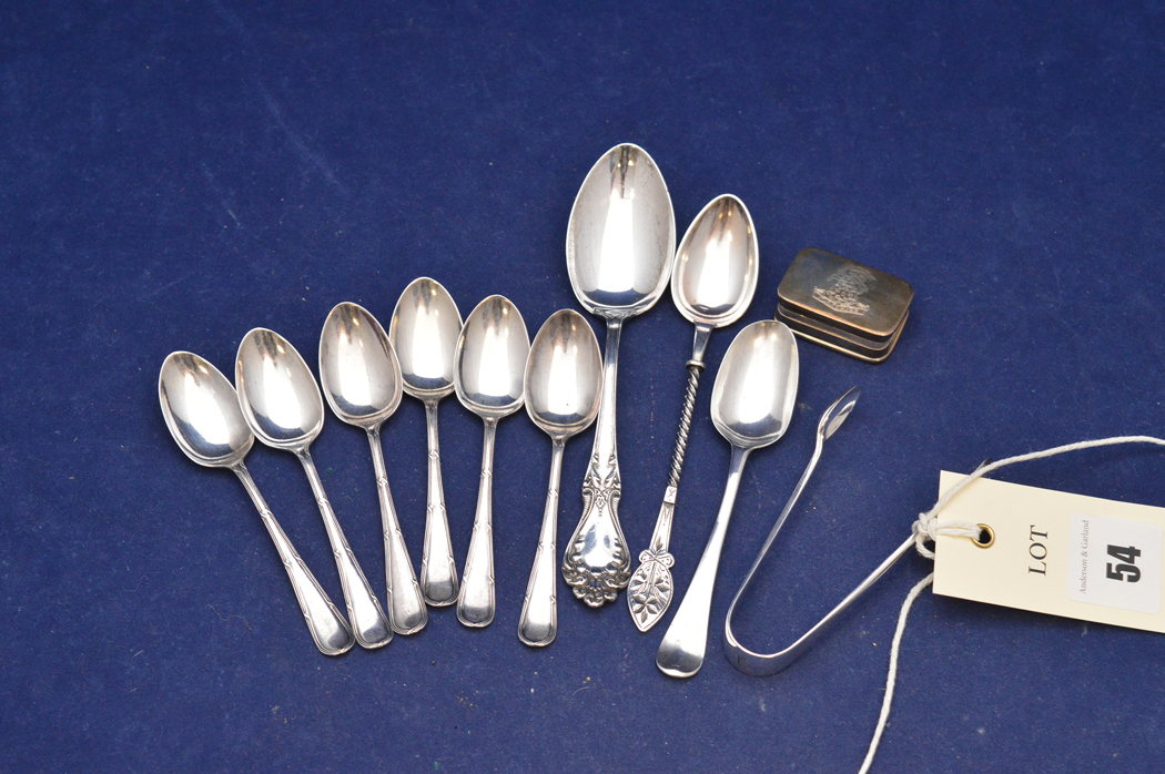 Silver teaspoons and sugar tongs