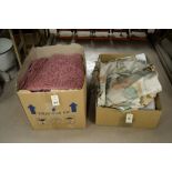 Two boxes containing curtains and material