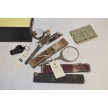 Silver magnifying glass, pocket watch and other items.