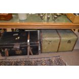 A vintage canvas covered and wooden framed two-handled trunk; and another with leather bindings.