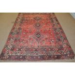 A South West Persian rug, the red field with central pole medallion, geometric pattern border, 372 x