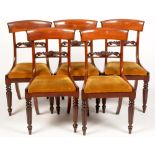 A set of five dining chairs.