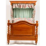 A Victorian satin walnut half-tester bedstead.