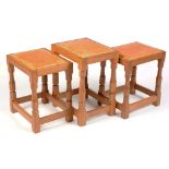 Robert Thompson of Kilburn: A 'Mouseman' stool; and two matching smaller stools.
