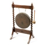 A late Victorian oak and brass gong.