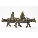 Pair of bronze water buffalo ornaments.