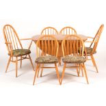 Ercol: a light elm and beechwood drop leaf table; and six chairs.