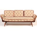 Ercol: a stained beech and elm studio couch.
