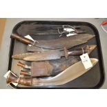 Two kukri knives, two fishing spear heads, and an African knife