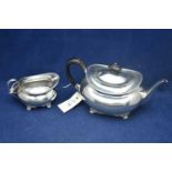 Silver teapot and cream jug