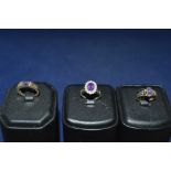 Three amethyst rings