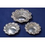 A pair of Victorian embossed silver bon bon dishes, and a larger matching dish,