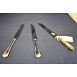 Three silver handled cake knives