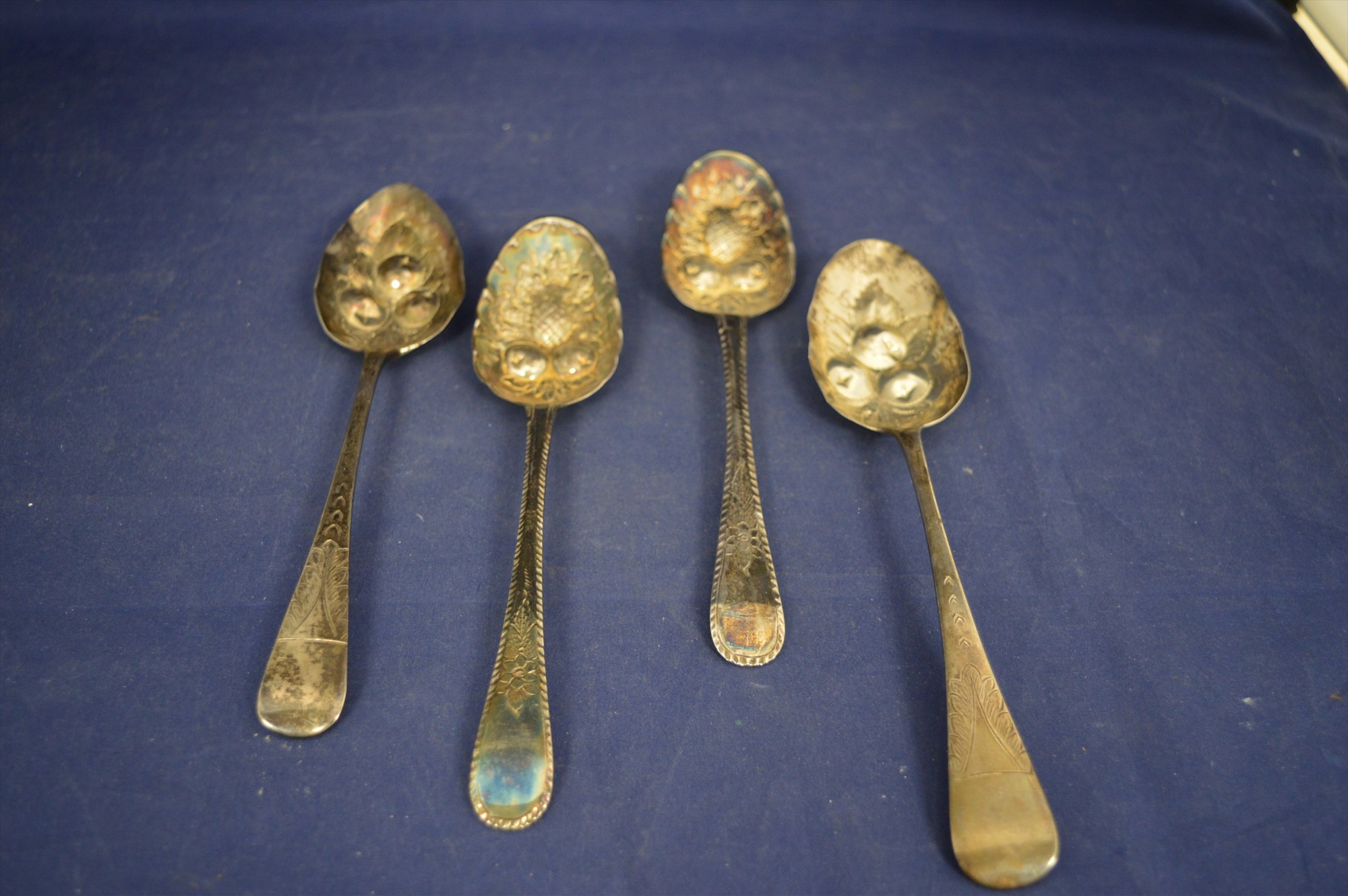 Four silver berry spoons