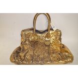 A gold coloured simulated reptile skin puffy soft hand bag