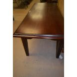 A modern rectangular dark stained wood dining table