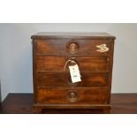 Miniature tabletop chest of four drawers.