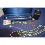 Costume jewellery including faux pearl necklaces and various cufflinks.