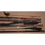 Miscellaneous fishing rods, pieces and parts; a reel and a rod slip.