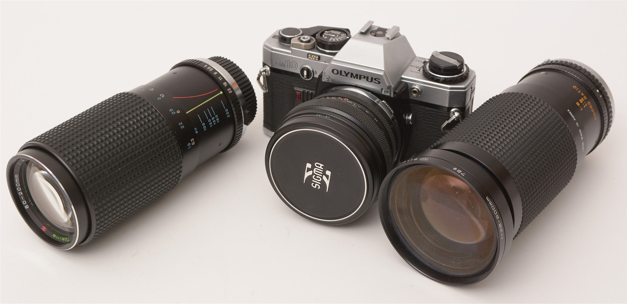 An Olympus camera and various lenses.