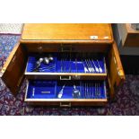 A late Victorian oak four-drawer canteen, containing a matched set of Wm. IV and Victorian fiddle