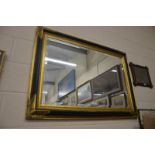 A Regency style rectangular black and gilt bevelled wall mirror