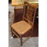 Set of four fruitwood and cane seated dining chairs with turned front legs and stretcher