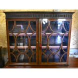 A 19th century mahogany bookcase with a pair of glazed doors enclosing adjustable shelves