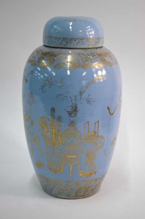 A Chinese claire-de-lune slender oviform vase with domed cover; highlighted in gilt with a design of