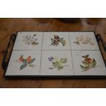 A wrought iron twin handled tray with six hand painted tiles