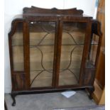 1930's carved rosewood display cabinet with a pair of glazed doors enclosing two shelves, raised